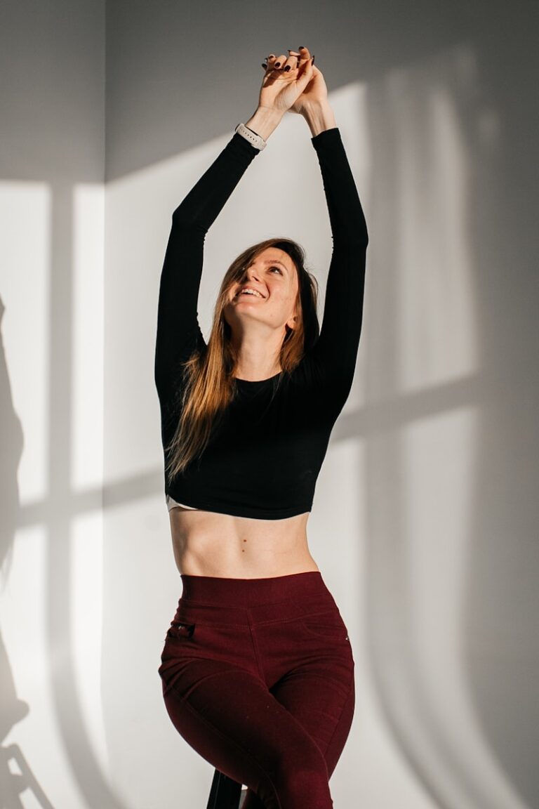 a woman in a black top and maroon pants
