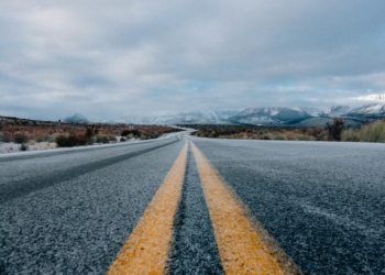 landscape photography of asphalt road under cloudy sky during daytime