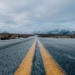 landscape photography of asphalt road under cloudy sky during daytime