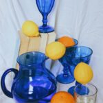blue glass pitcher with lemon fruits