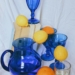 blue glass pitcher with lemon fruits