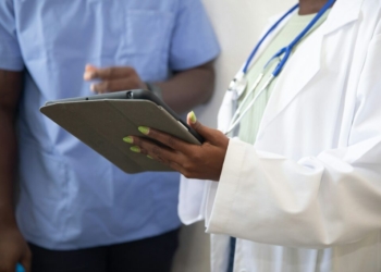 a doctor showing a patient something on the tablet