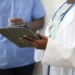 a doctor showing a patient something on the tablet