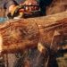 a man using a chainsaw to cut a log