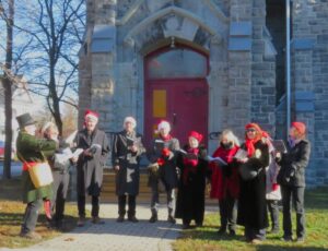 A group of carolers outside of church