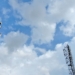 a group of cell towers sitting under a cloudy blue sky