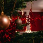 gold baubles on green christmas tree