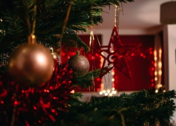 gold baubles on green christmas tree