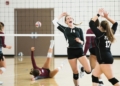 women playing volleyball inside court