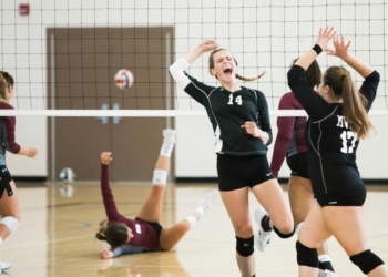 women playing volleyball inside court