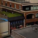 Modern cafe sign on brick building rooftop