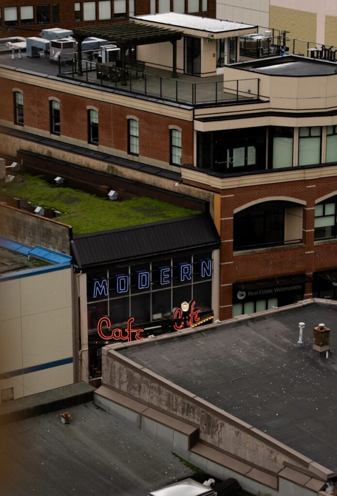 Modern cafe sign on brick building rooftop
