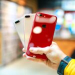 person holding red iphone case