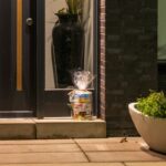 Gift wrapped package on doorstep near front door