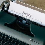 A vintage typewriter with a paper titled 'News', symbolizing journalism and communication.