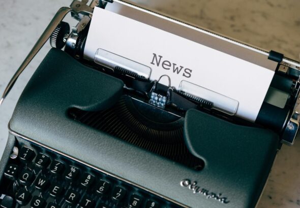 A vintage typewriter with a paper titled 'News', symbolizing journalism and communication.