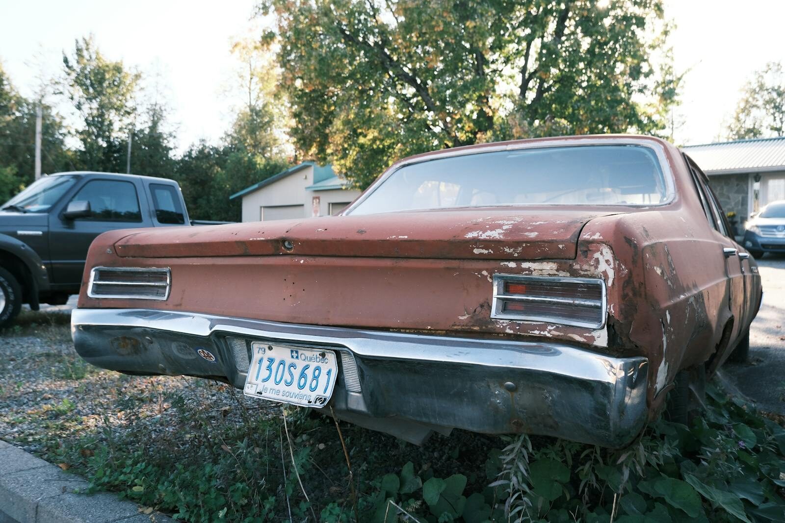 Aged classic car with rust and patina parked outdoors in Gatineau, Quebec, Canada.