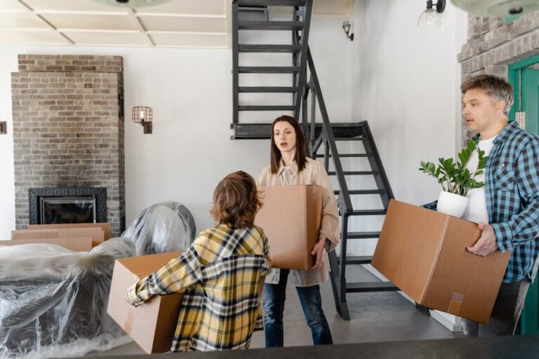 A family carries cardboard boxes into the front hallway of a new Ontario home