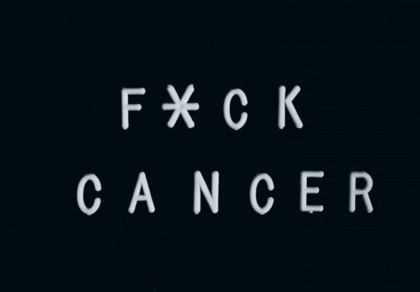 Motivational anti-cancer message on a letter board, emphasizing awareness.
