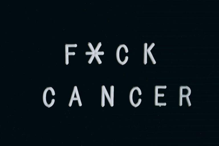 Motivational anti-cancer message on a letter board, emphasizing awareness.