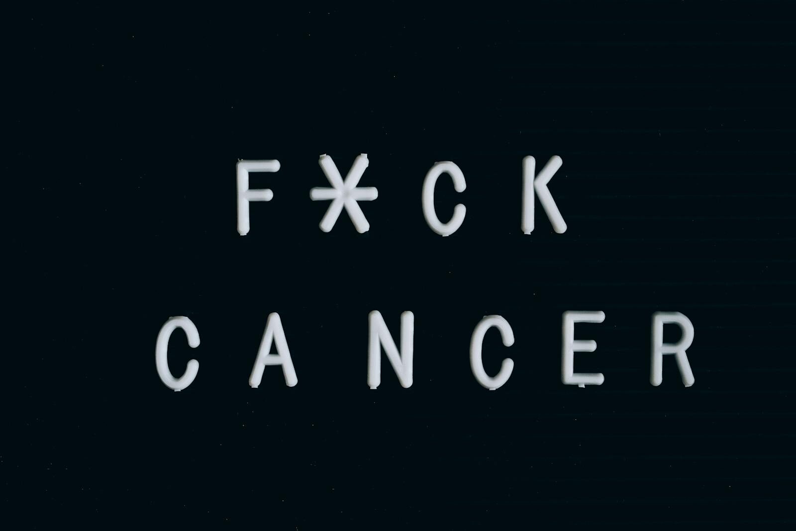 Motivational anti-cancer message on a letter board, emphasizing awareness.