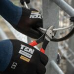 a pair of hands holding a pair of pliers