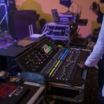 a man standing in front of a sound board