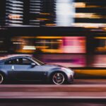 panning photography of gray coupe on road