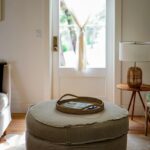brown woven basket on gray ottoman