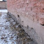 a brick wall that has been partially covered in snow