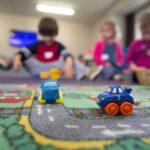 a group of children playing with toys on the floor