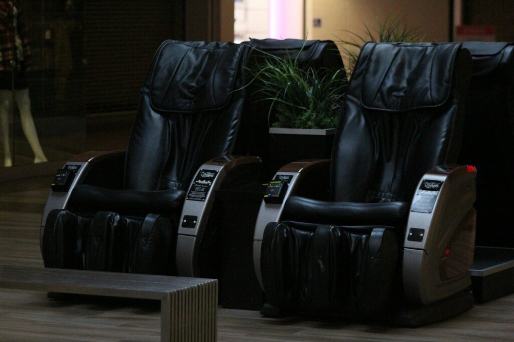 A couple of black chairs sitting on top of a hard wood floor