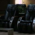A couple of black chairs sitting on top of a hard wood floor