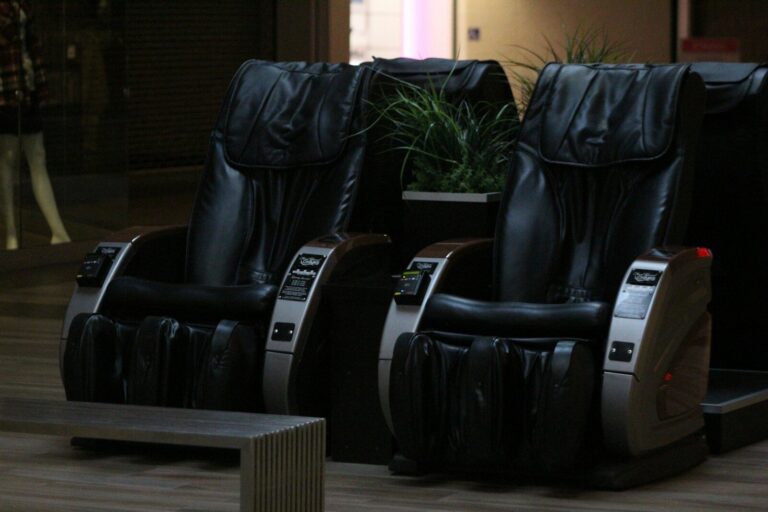 A couple of black chairs sitting on top of a hard wood floor