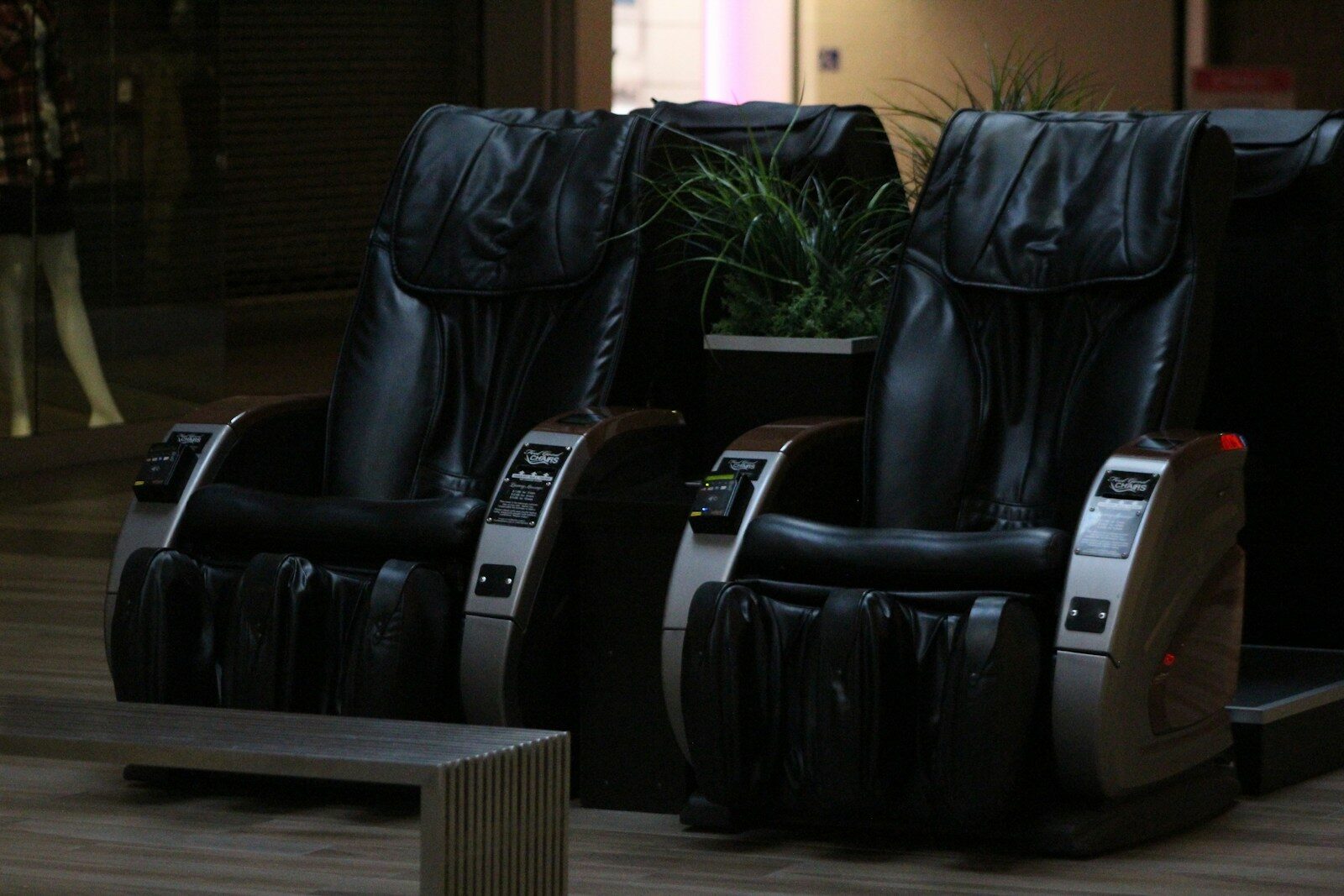 A couple of black chairs sitting on top of a hard wood floor