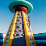 a man climbing up the side of a large inflatable structure