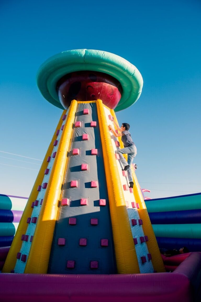 a man climbing up the side of a large inflatable structure