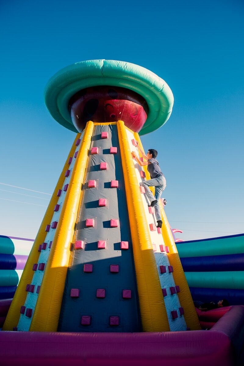a man climbing up the side of a large inflatable structure