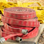 a pile of fire hoses sitting on top of a cement slab