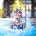 girl swims on swimming pool
