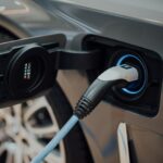 electric vehicle charging cable plugged into car