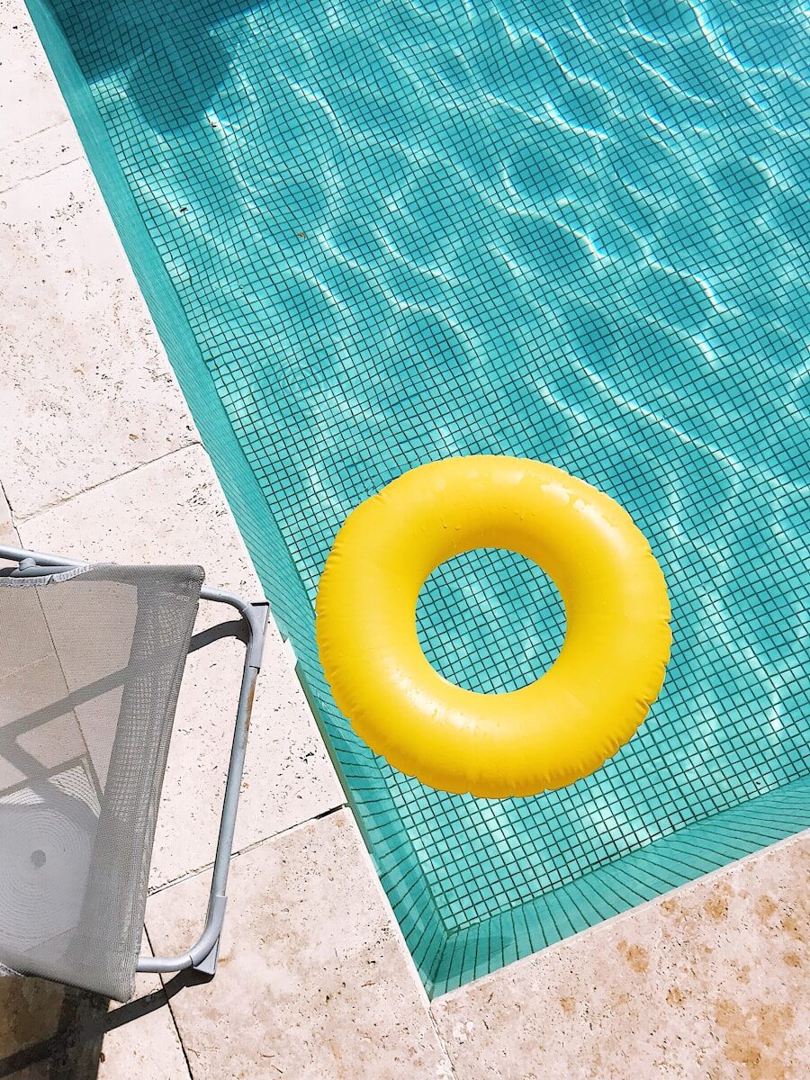 yellow pool float on swimming pool edge