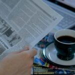 A man reads the morning news over a cup of coffee