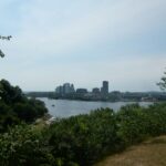 Ottawa River and Gatineau skyline viewed through green trees