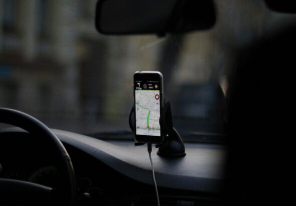 black iphone 4 on car seat