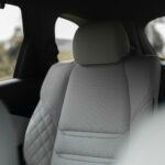the back seats of a car with a view of a field