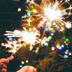 a person is holding a sparkler in their hand