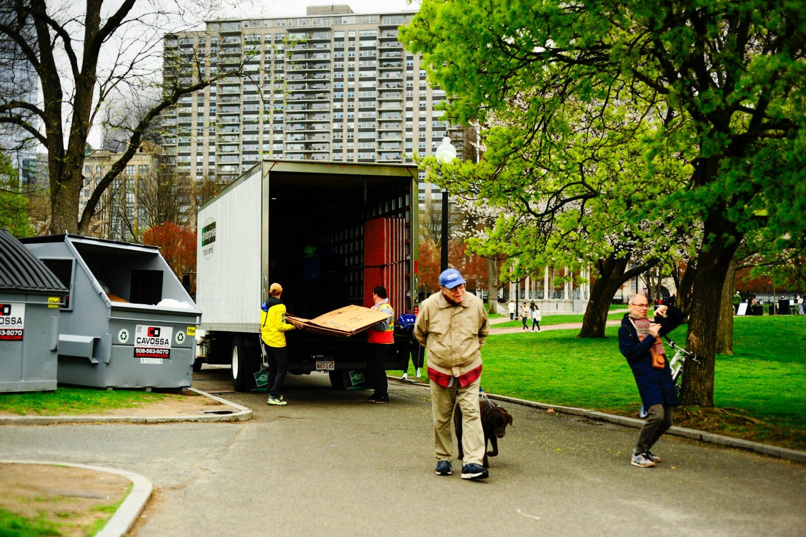 People unloading furniture from a moving truck outdoors