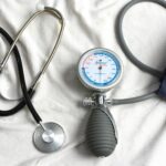 a stethoscope laying on top of a bed next to a medical bag