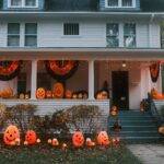 A house decorated for halloween with pumpkins and lights